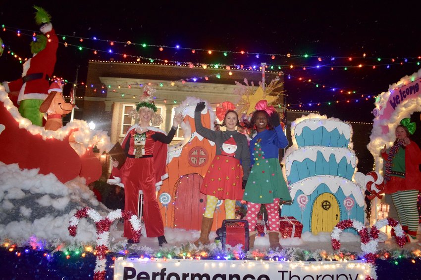 Alaina Pilgrim, Kate Steele and Amisha Sudberry wave from the Performance Therapy float during the 2021 Christmas Parade. Performance Therapy was named the Best Overall float.